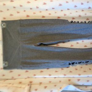 Grey yoga pants with open design on the outer calf